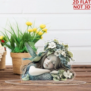 Close-up of 2D acrylic girl figurine with floral wreath on a wooden desktop base