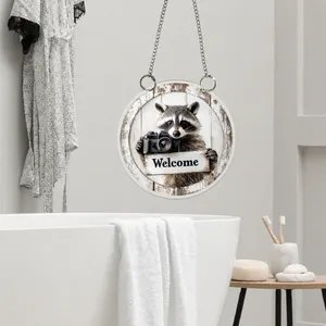 Close-up of 2D acrylic welcome sign with raccoon illustration in bathroom setting