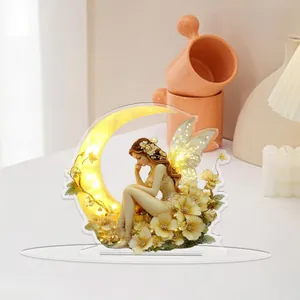Detailed 2D acrylic stand showing a fairy on a crescent moon with floral accents
