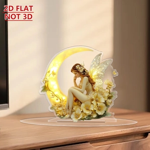 Close-up of 2D flat acrylic fairy on moon desktop ornament with floral details