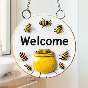 Close-up of 2D flat acrylic Welcome sign featuring bee and honeycomb patterns with hanging chain