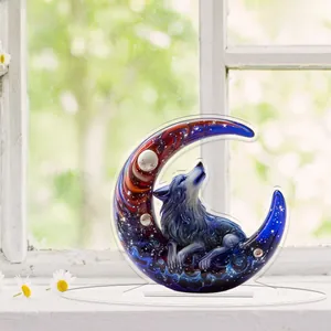 Detailed view of 2D acrylic wolf moon crescent ornament with a transparent base on a windowsill