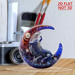 Flat 2D acrylic moon and wolf ornament featuring starry night art on a wooden desktop