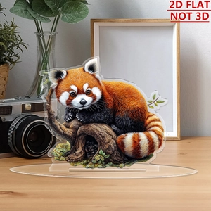 Flat 2D acrylic red panda ornament with transparent base on a wooden desk