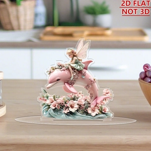 Detailed 2D acrylic stand showing a green fairy on a pink dolphin over wooden desk