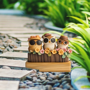 Detailed view of creative resin owl garden stakes with sun hats on rustic wood base