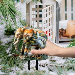 Detailed close-up of decorative elephant garden stake with mountain landscape print