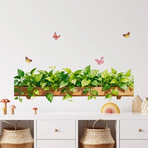 Detail view of green plant and butterfly wall decals in a stylish living room background