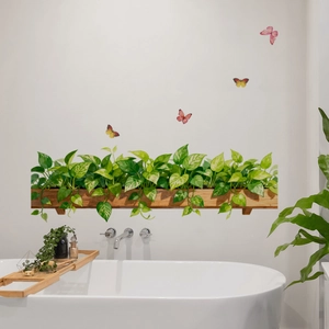Macro detail of watercolor green potted plants and butterfly wall stickers in bathroom