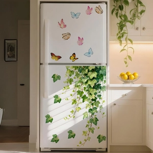 Detail of green vine and butterfly wall stickers applied on a refrigerator surface