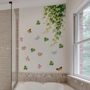 Detail of ivy leaf and colorful butterfly wall stickers in a modern bathroom setup
