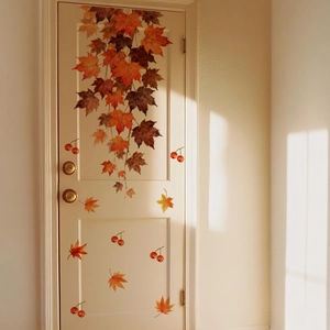 Detailed view of autumn maple leaf wall stickers applied to a wooden interior door