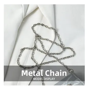 Detailed view of elegant silver butterfly chain and grey lychee texture saddle bag leather
