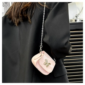Detailed close-up of pink marble pattern mini saddle bag with golden butterfly buckle