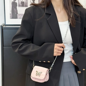 Mini pink saddle bag with gold butterfly buckle and silver chain strap on model