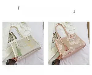 Detail of embroidered floral bucket bag with tassel in beige and pink color options
