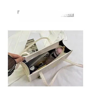 Top view of open beige tote bag showing spacious interior with iPad and phone