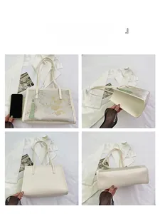 Detail of Chinese style bucket bag with floral embroidery and tassel accessory