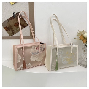 Close-up of floral embroidery on Chinese style tote bags with elegant tassel detail