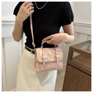 Detailed view of pink marble fluid pattern texture and golden buckles on a leather handbag
