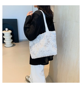 Detailed view of white butterfly tote bag featuring soft feathery texture and canvas straps