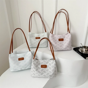 Modern textured tote bags in white, green, and pink with brown leather straps
