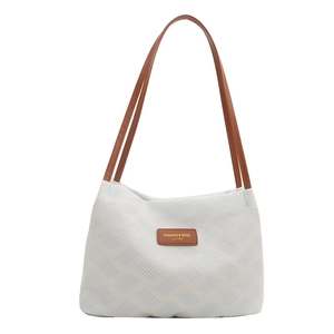 Minimalist beige woven tote bag with blue stripes and brown leather straps for women