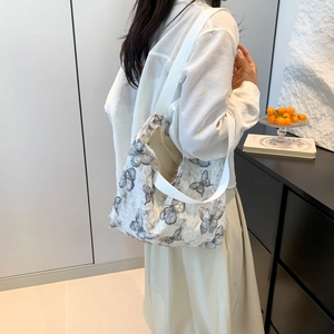 Minimalist white tote bag with black butterfly embroidery pattern for women