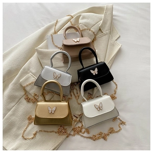 Collection of mini crossbody bags with bow clasp detail in various metallic finishes