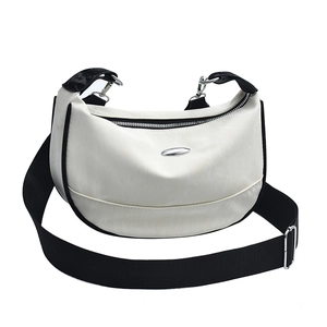 White crescent shoulder bag with black trim and wide adjustable strap on white background