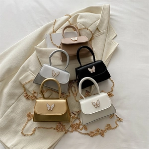 Mini crossbody bags with bow accent and gold chain straps in multiple trendy colors