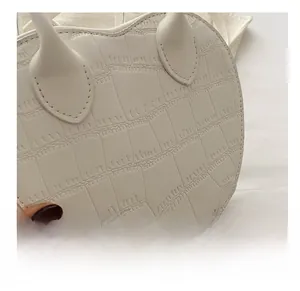 Detailed macro view of white crocodile pattern leather texture on a chic handbag