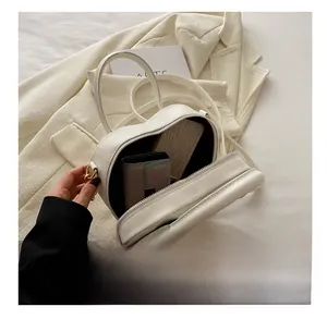 Capacity display of white heart-shaped leather bag with wallet and phone inside