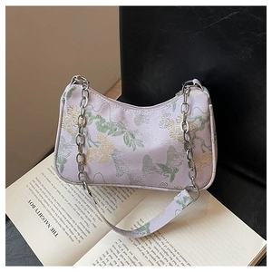 Detail of lavender floral jacquard fabric and silver chain on Chinese style handbag