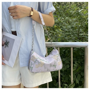 Detail of lavender crescent bag with floral embroidery and silver chain strap