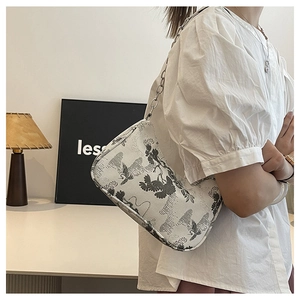 Detail of white canvas shoulder bag with traditional Chinese ink painting and silver chain