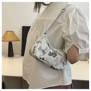 Detailed shot of half-moon underarm bag with traditional crane print and chain strap