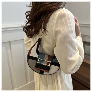 Detail of crescent shoulder bag with geometric color blocks and gold buckle