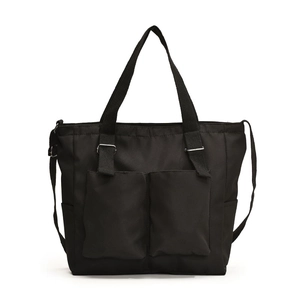 Minimalist black nylon crossbody tote bag with large front pockets and adjustable straps