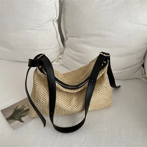 Straw woven tote bag with contrast black leather strap and metal buckle for summer beach
