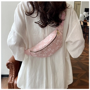 Detailed back view of a pink crescent bag with floral texture on a female model
