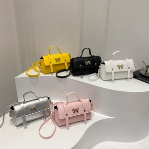 Retro crossbody bags in five colors with metallic bow detail and top handles