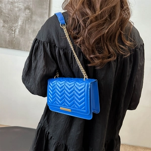 Chic electric blue V-quilted crossbody bag with gold chain strap for women's summer style