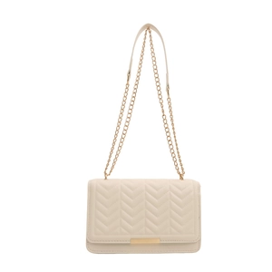 Minimalist beige crossbody bag with V-quilted texture and gold chain strap on white background