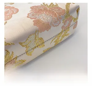 Macro detail of Chinese style floral embroidery and premium stitching on a cream tote bag