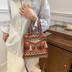 Detailed shot of ethnic crossbody bag with colorful tassels and geometric woven pattern