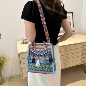 Close-up of bohemian shoulder bag featuring colorful geometric patterns and long tassels