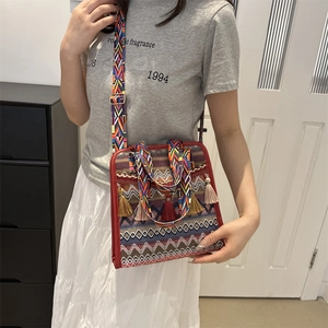 Bohemian crossbody bag with colorful geometric patterns and five fringe tassels detail