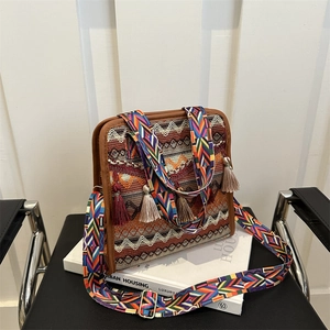 Close-up of bohemian woven crossbody bag with colorful jacquard patterns and tassels