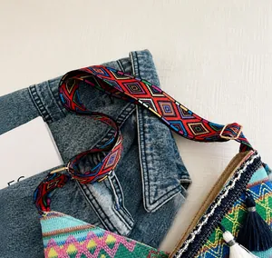 Etnisch geborduurde tas met brede geometrische geweven riem en decoratieve franje details